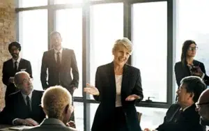 Bridging Generational Differences and Workplace Collaboration 15 Businesswoman speaking with peers during an office gathering
