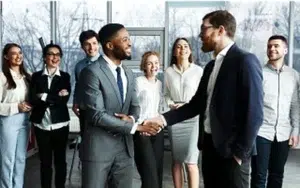 Building Customer Loyalty Through Needs Analysis 18 Manager shaking hands with an employee as colleagues look on