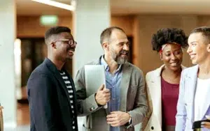 Conflict Resolution Strategies for Win-Win Workplace Outcomes 31 Diverse coworkers smiling and talking in an office corridor