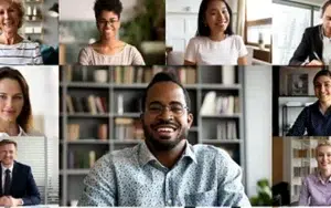 Effective Communication for Remote & Hybrid Teams 49 Video call grid of smiling remote workers on a laptop screen