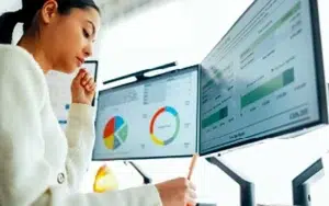 Microsoft Visio Intermediate: In-Depth Process and Workflow Mapping 21 Professional analyzing charts on dual monitors