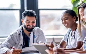 Project Communication and Stakeholder Management Skills for PMs 22 Smiling healthcare professionals reviewing information together at a table
