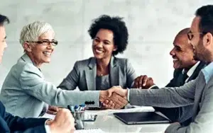 Building Trust at Work: Empower Authentic Team Connections 20 Smiling colleagues shaking hands during a team meeting