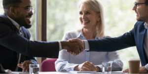 Banner image. African and caucasian millennial businessmen colleagues shaking hands on meeting in office, diverse enterpreneurs striking good deal, multiethnic teammates succeed in common project work - Influence Without Authority