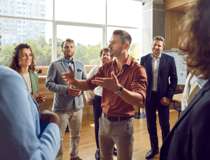 Corporate trainer leading professionals in a modern office learning session.