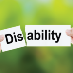 A sign saying "disability" while someone is ripping it