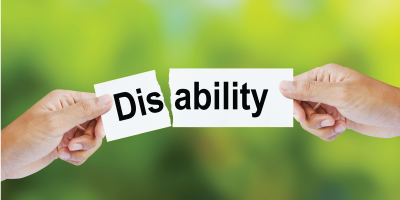 A sign saying "disability" while someone is ripping it