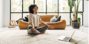 Young multiracial latina woman meditating at home with online video meditation lesson using laptop. Meditation and spirituality concept. - mindfulness - Strategies for Managing Stress