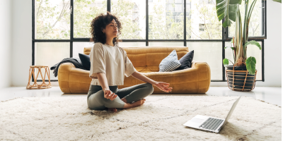 Young multiracial latina woman meditating at home with online video meditation lesson using laptop. Meditation and spirituality concept. - mindfulness - Strategies for Managing Stress