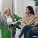 Diversity, mental health and group therapy counseling support meeting, healthy conversation and wellness. Psychology counselor, psychologist help people and talk about anxiety, depression or stress stock photo - Making Change Work for You