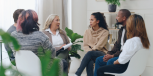 Diversity, mental health and group therapy counseling support meeting, healthy conversation and wellness. Psychology counselor, psychologist help people and talk about anxiety, depression or stress stock photo - Making Change Work for You