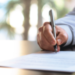 Businessman Signing An Official Document - Essentials of Better Business Writing