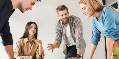 A group of business professionals coming together and facilitating tasks of a project.