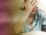 Overwhelmed female office worker showing stress at workplace