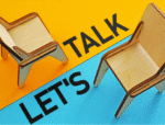 Two chairs against a bright yellow and teal vertical background with the text 'Can We Talk?' symbolizing serious workplace conversations.
