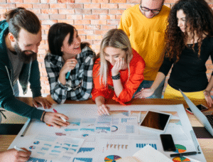 Collaborative team of generation z professionals analyzing data together at work.