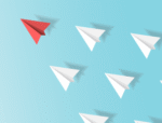 White paper airplanes following a red airplane representing leadership.