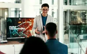 Super Intelligence for Federal Leadership and Decision-Making 43 Leader presenting a digital transformation slide to colleagues