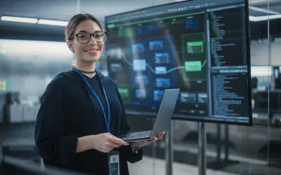 Woman with laptop in tech environment
