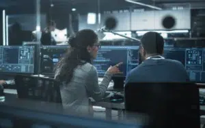 Two professionals collaborating at computers.